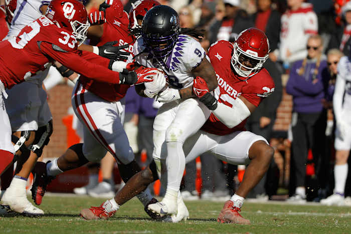 Nov 24, 2023; Norman, Oklahoma, USA; Oklahoma Sooners defensive lineman R Mason Thomas (32) tackles TCU Horned Frogs running back Emani Bailey (9) at Gaylord Family-Oklahoma Memorial Stadium.